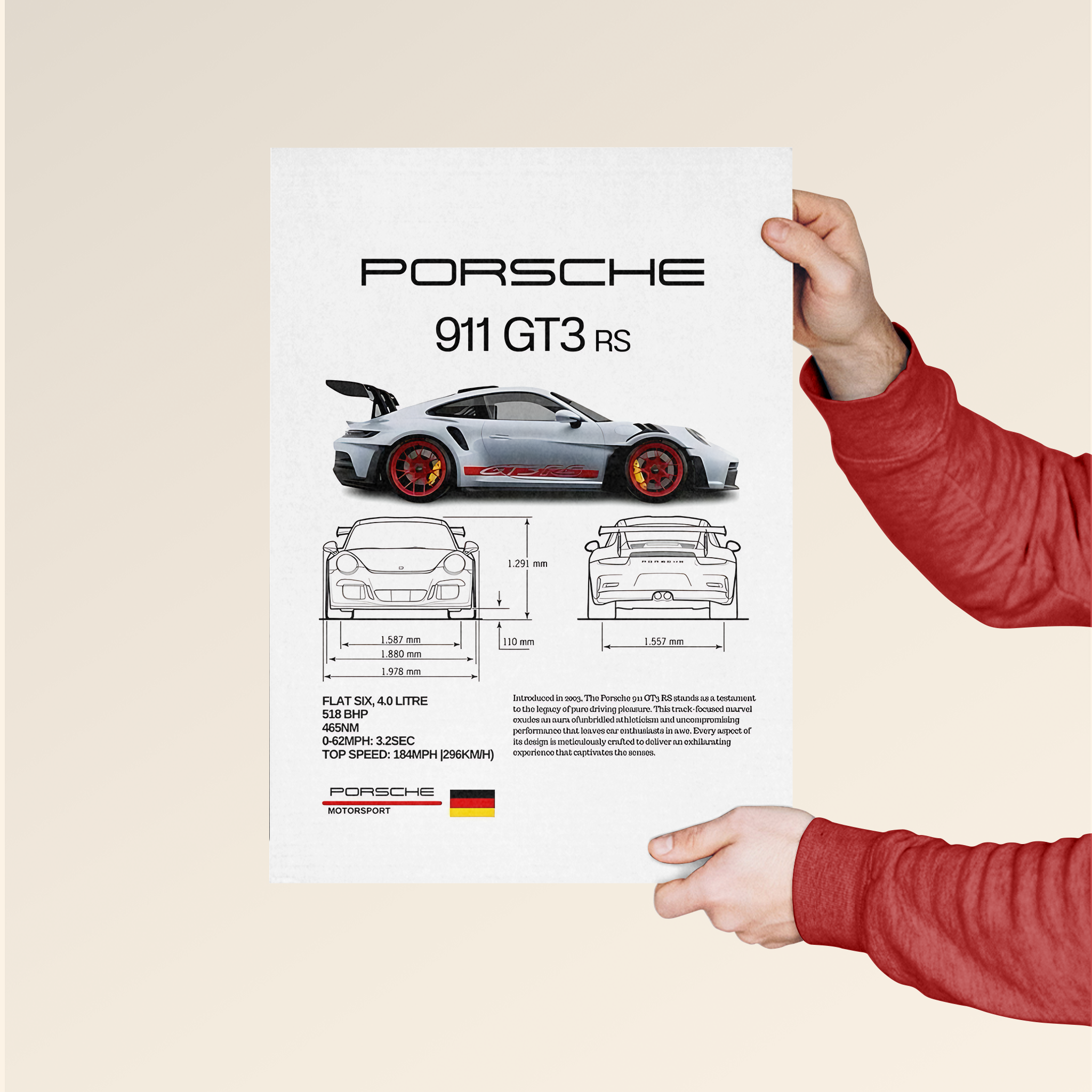 Porsche 911 poster featuring detailed car design and specifications held by person in red sweater